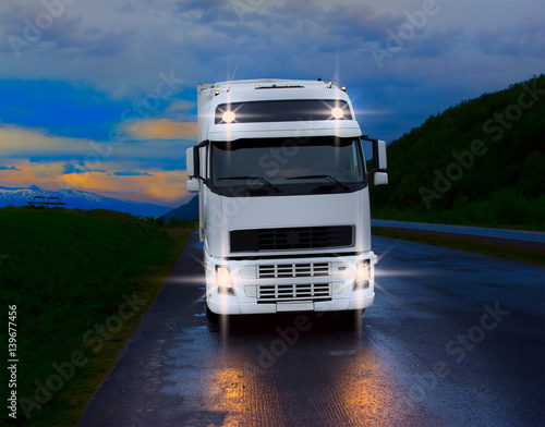 White truck on the rural road at the night