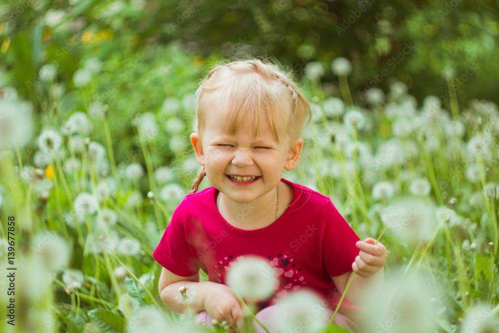Cute little girl smiling with dandelions Cute little girl smiling with dandelions