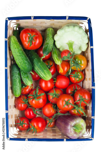 Basket with vegetables for salad on white background