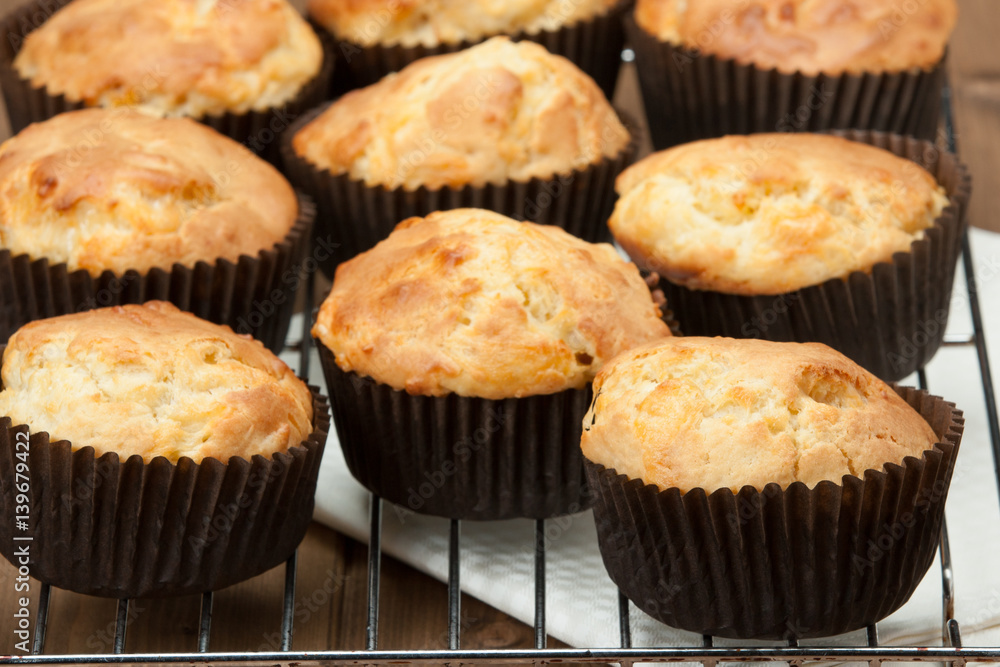 Homemade Cheddar Muffins In Paper Cases. Wooden Table. Homemade Cheddar Muffins In Paper Cases. Wooden Table.