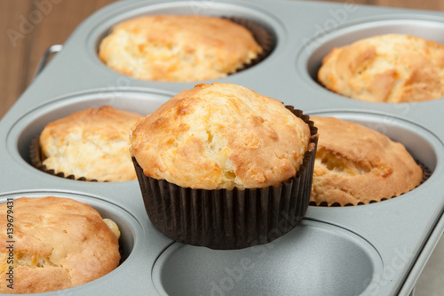 Homemade Cheddar Muffins In Baking Tray. Wooden Table.