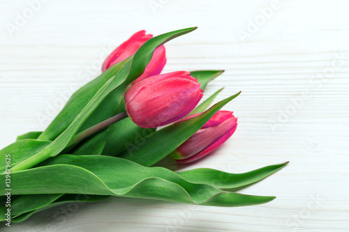 Fototapeta Naklejka Na Ścianę i Meble -  Pink tulips on a white table