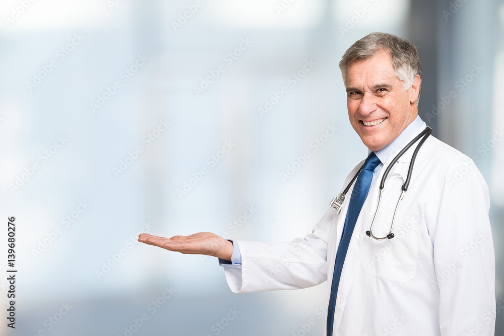 Senior doctor presenting and showing copy space for product or text Senior doctor presenting and showing copy space for product or text