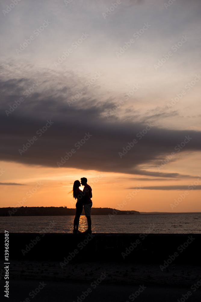 Couple in love on the background of beautiful sunset