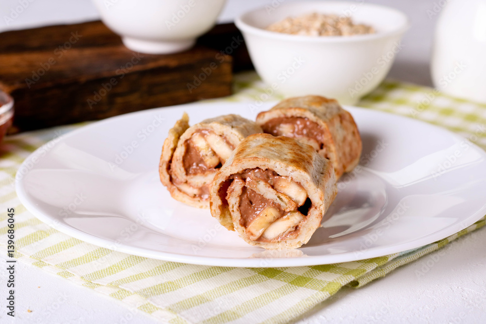 crepes with chocolate filling and banana, horizontal crepes with chocolate filling and banana, horizontal