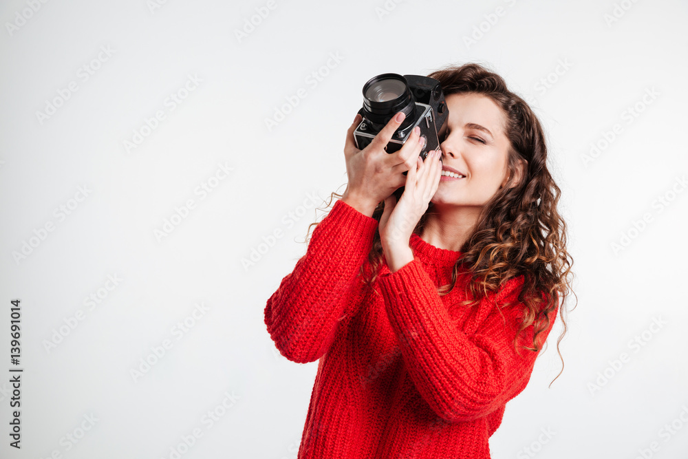 Smiling curly girl with retro camera Smiling curly girl with retro camera