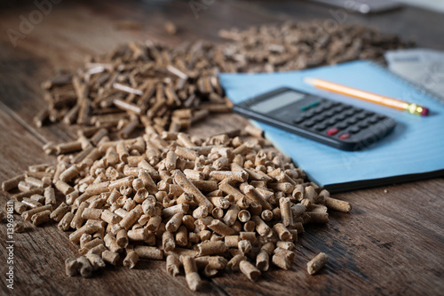 Calculating household heating costs. Wooden pellets, biomass, effective, environmentally friendly and economical heating, sustainable and renewable energy photo