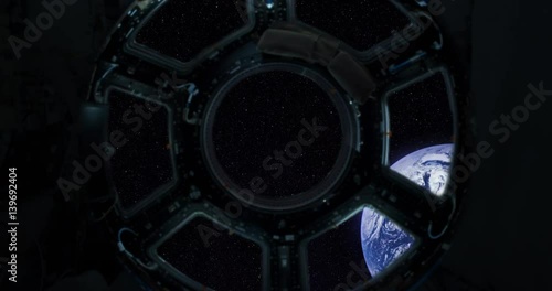 Spaceship window / Space travel / Planet Earth. Elements of this clip furnished by NASA. Porthole of spacecraft heading to Earth.
