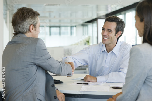 Businessman shaking hands with client photo