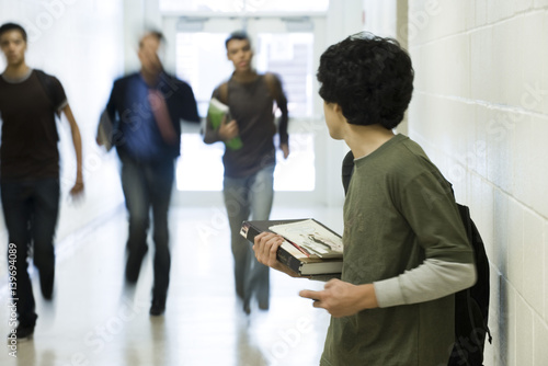 Teenage boy running from bullies