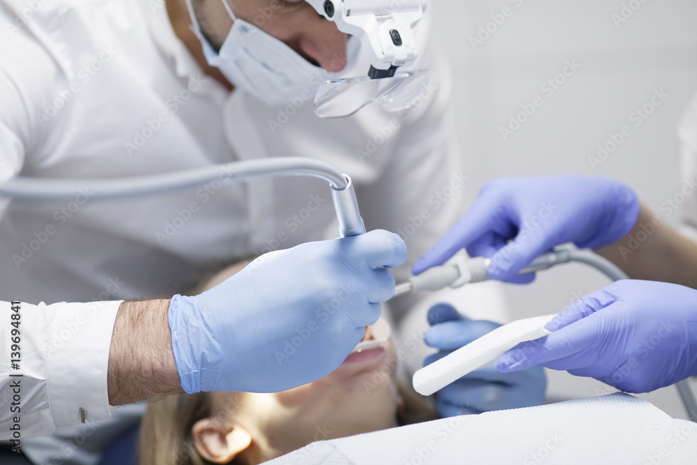 Dental cure. Molar treatment. Young female patient visiting dentist office. Dental cure. Molar treatment. Young female patient visiting dentist office.