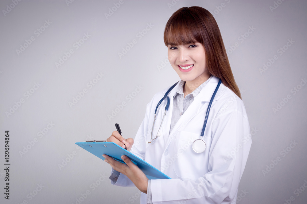 Healthy concept : Young Asian doctor writing on clipboard for patient chart Healthy concept : Young Asian doctor writing on clipboard for patient chart