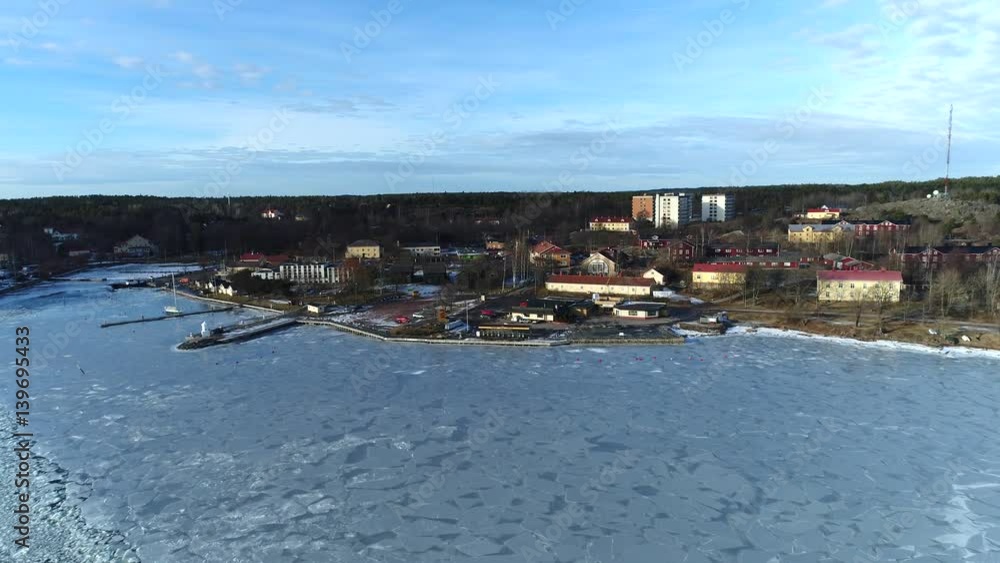 Taalintehdas town, UHD Aerial view of a flight towards Taalintehdas town, on a sunny winter day, in finnish archipelago, in Kemiönsaari, Varsinais-suomi, Finland Taalintehdas town, UHD Aerial view of a flight towards Taalintehdas town, on a sunny winter day, in finnish archipelago, in Kemiönsaari, Varsinais-suomi, Finland