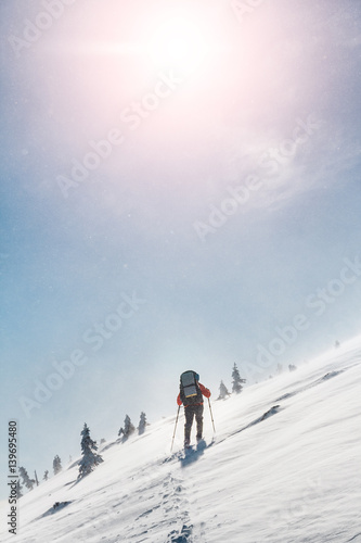 Ski touring in extreme winter conditions at snow storm and blizzard