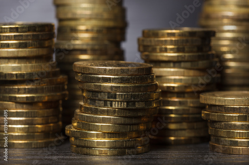 Stacks of gold coins on black background