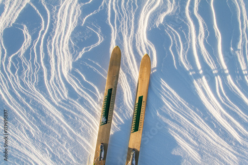 Pair of wooden skis on the snow