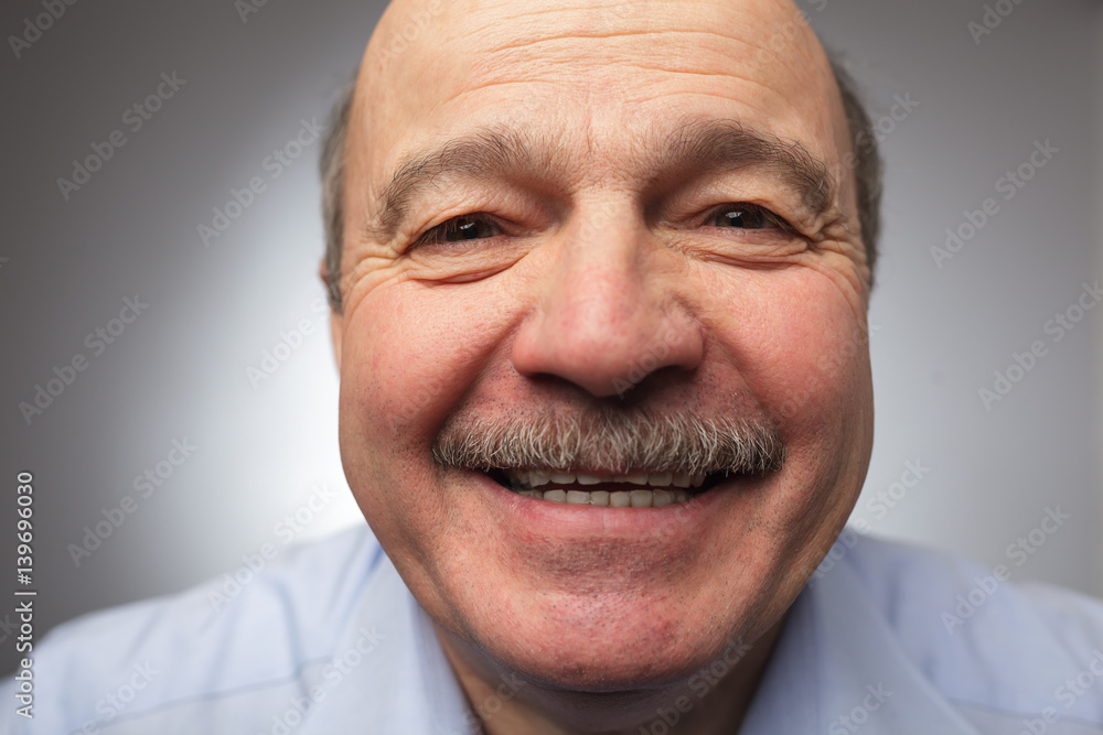 Elderly man laughs from ear to ear, giggles on the funny stories. Be happy of news or events Elderly man laughs from ear to ear, giggles on the funny stories. Be happy of news or events