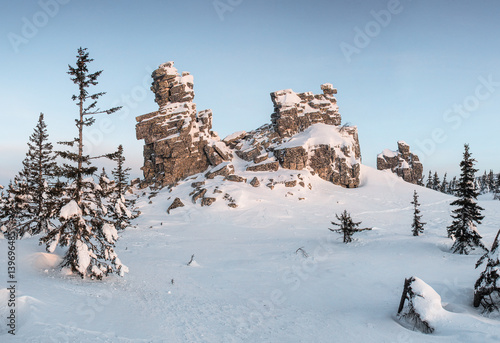 Cliffstone in winter mountains at sunrise photo