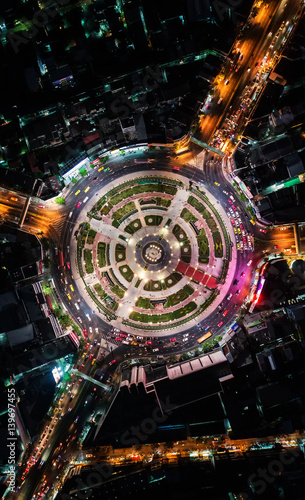 Road roundabout with car lots Wongwian Yai in Bangkok,Thailand. street large beautiful downtown at evening light. Aerial view , Top view ,cityscape ,Rush hour traffic jam