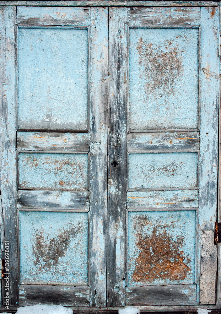 Naklejka premium Vintage old blue wooden door with cracked paint