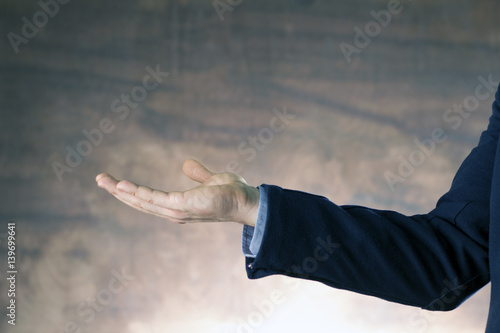 Businessman showing by hand