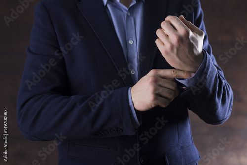 businessman buttons cuff of the sleeve © Aerial Mike