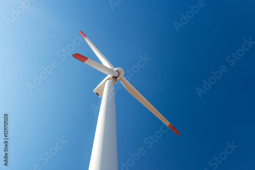 Wind turbines against a blue sky generating electricity