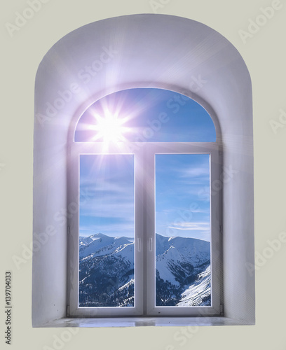 white semicircular modernist windows on a white wall.winter  sky  clouds  sun  mountains in the window
