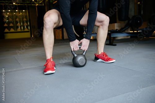 Cropped image of Athletic man doing exercise with weight