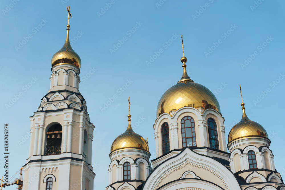 Golden domes of the Orthodox church against the blue sky, Voronezh, Russia