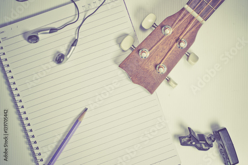 concept song composer:Notebook and pencil ,Ukulele ,style vintage