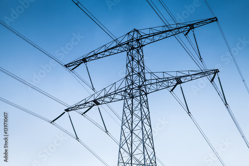 Electricity pylon over blue sky