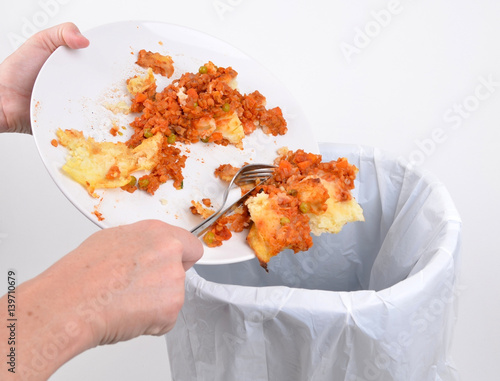 Scraping food into a household rubbish bin