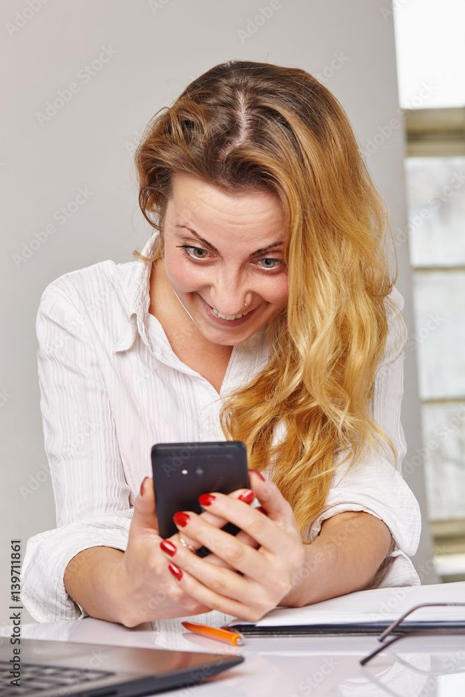 Woman reading something on her mobile phone Woman reading something on her mobile phone