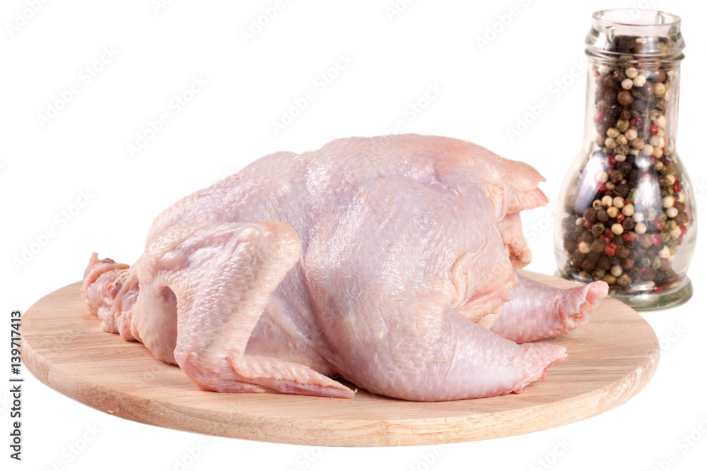 raw chicken carcass with peppercorns on the cutting board isolated on white background raw chicken carcass with peppercorns on the cutting board isolated on white background
