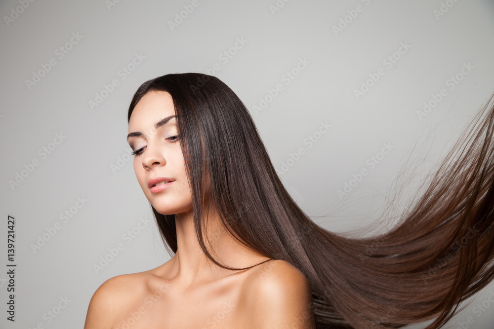 Young woman posing with her gorgeous long flying hair. Young woman posing with her gorgeous long flying hair.