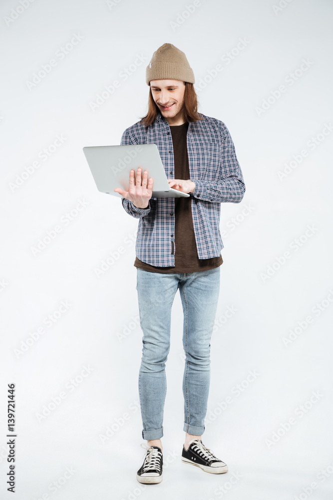 Vertical image of hipster using laptop