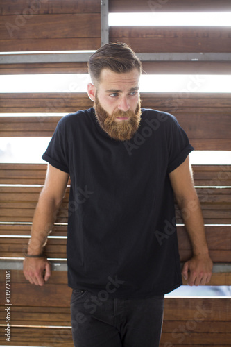 Bearded man posing in the street.