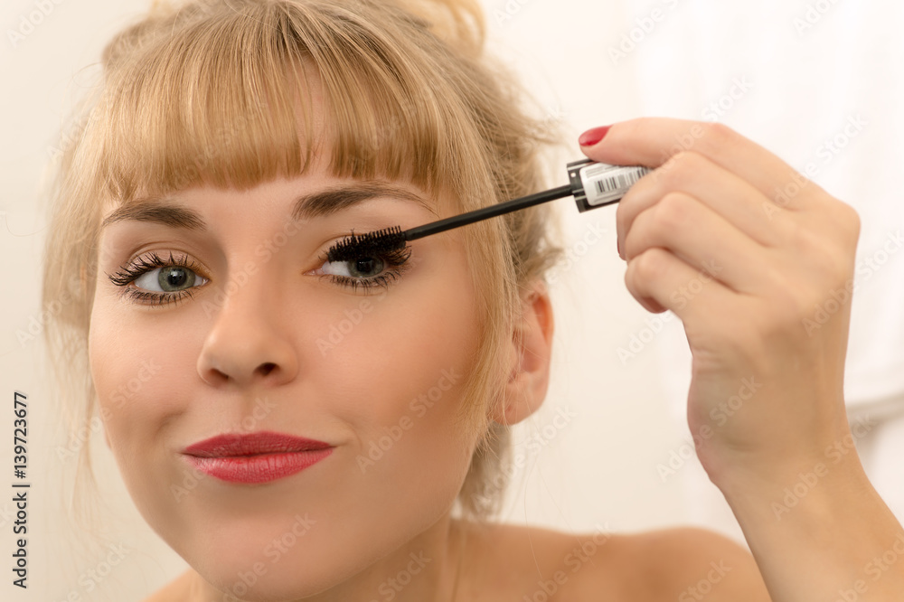 beautiful woman using mascara eyeliner closeup beautiful woman using mascara eyeliner closeup
