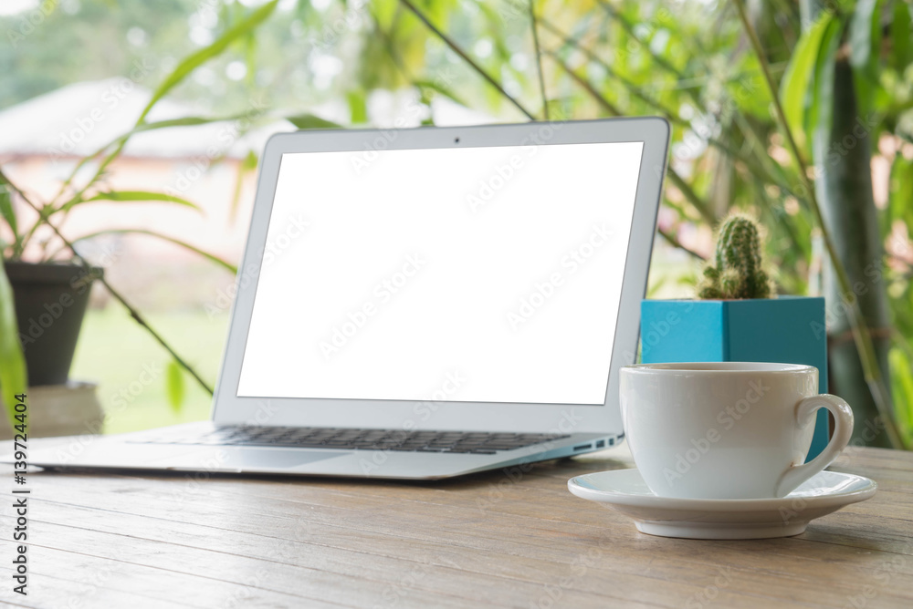 Fototapeta premium Laptop on a wooden table outdoors