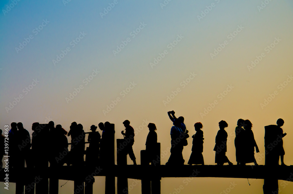 Silhouette of Traveler on the U penn bridge while Sunset.