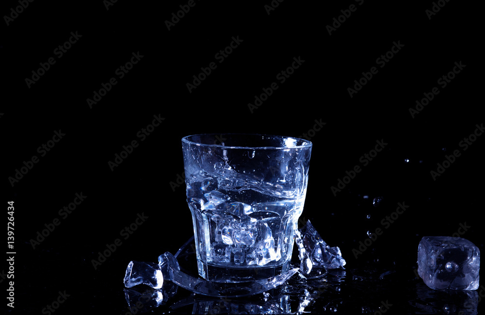 Water splash in a glass. A glass of cold water. Cold water with ice ...