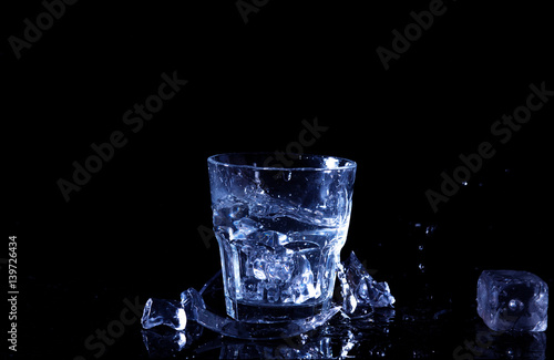 Water splash in a glass. A glass of cold water. Cold water with ice