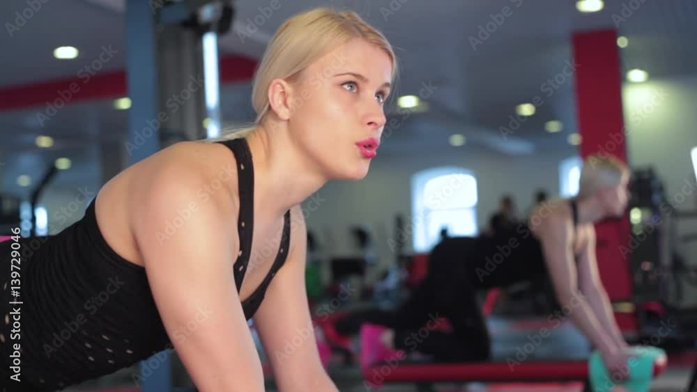 Young female athlete doing leg raises exercise at gym Young female athlete doing leg raises exercise at gym