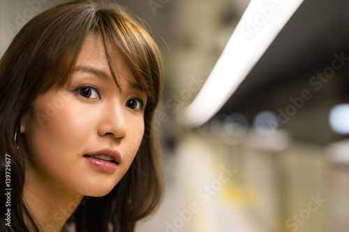Asian girl awaiting in train station