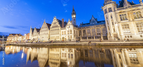 GENT, BELGIUM - MARCH 2015: Tourists visit ancient medieval city at night. Gent attracts more than 1 million people annually