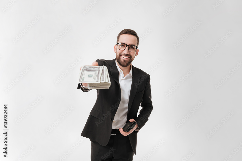 Happy young bearded businessman showing money to camera. Happy young bearded businessman showing money to camera.