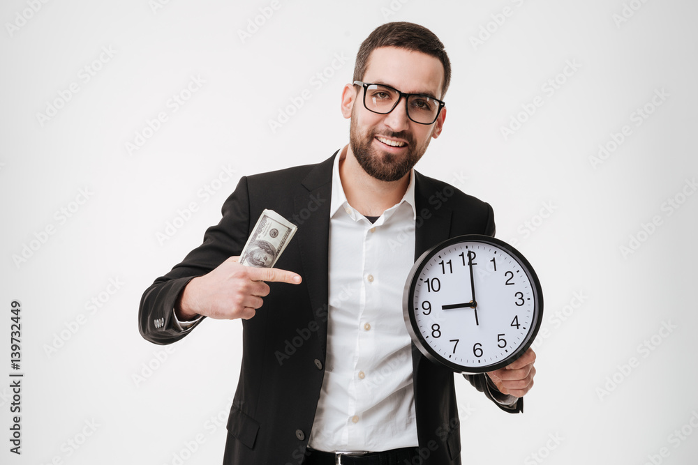 Bearded businessman holding money and pointing to watch. Bearded businessman holding money and pointing to watch.