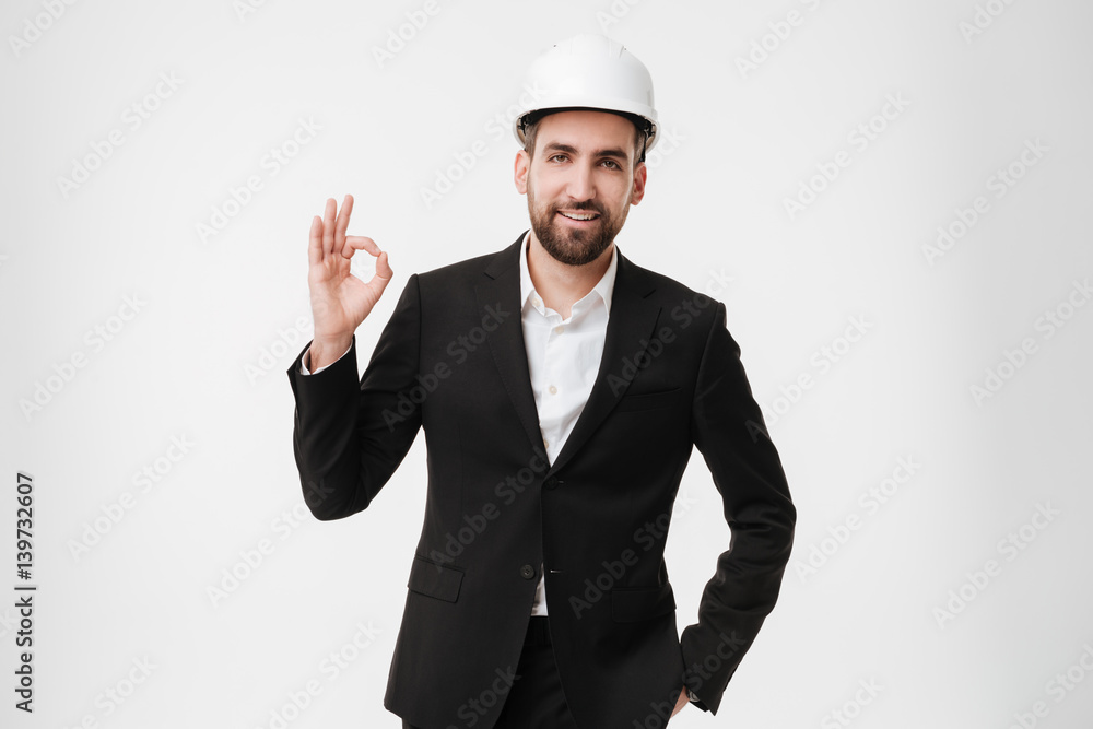 Attractive architect wearing helmet make okay gesture. Attractive architect wearing helmet make okay gesture.