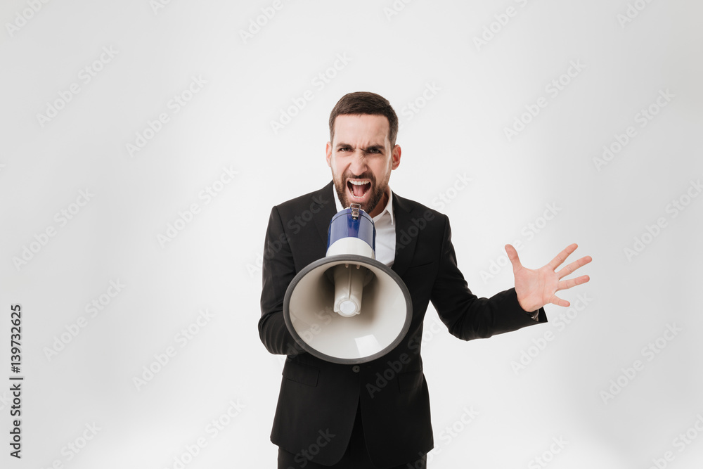 Fototapeta premium Screaming businessman talking with loudspeaker.
